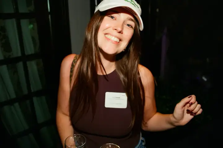 Guest smiling in a white cap