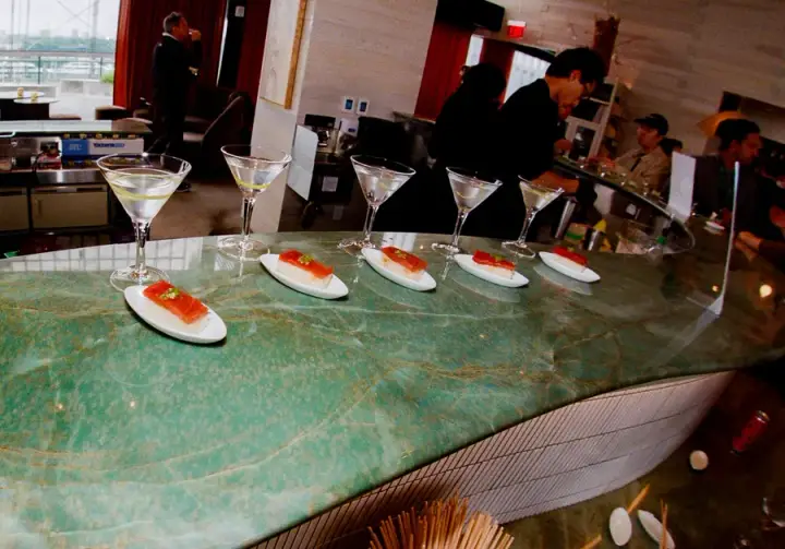 Cocktails and bites lined up on a bar