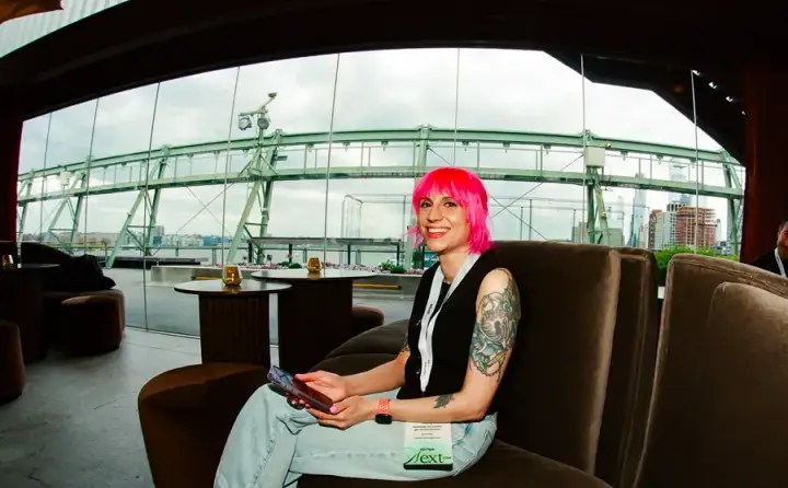 Attendee with pink hair relaxing at an AirOps event