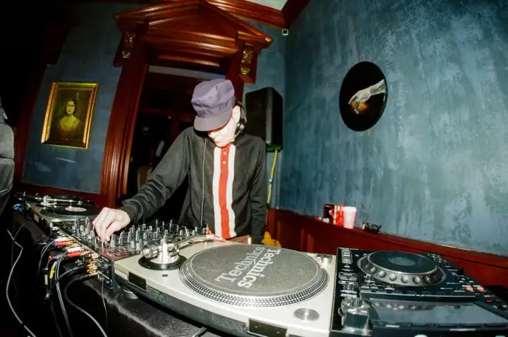 DJ mixing records in the blue lounge